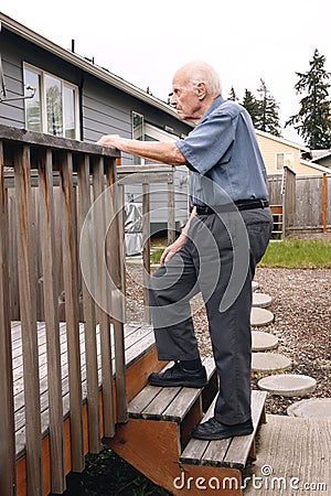 Senior walks up wooden deck steps outside