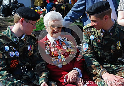 Senior war veteran and two young military men