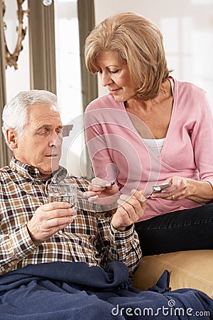 Senior Woman Caring For Sick Husband