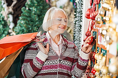 Senior Woman Choosing Christmas Ornaments