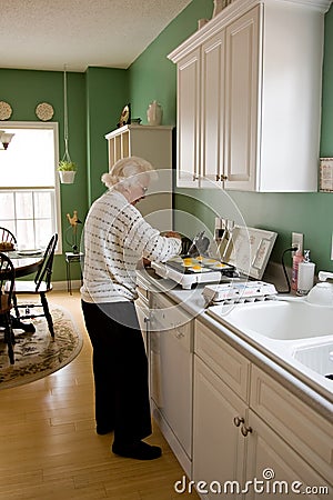 Senior woman cooking breakfast