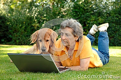Senior woman with dog at Laptop
