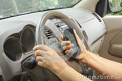 Senior woman driving car and calling mobile phone