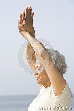 Senior Woman With Eyes Closed In Yoga Pose