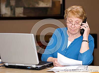 Senior woman filing taxes on line