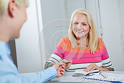 Senior woman giving electronic health card