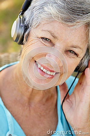 Senior woman with headphone smiling