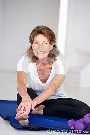 Senior woman at home exercising