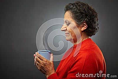 Senior woman with hot cup of tea