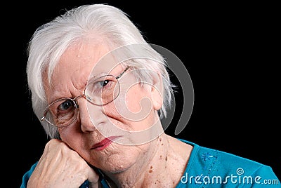 Senior woman leaning on hand with black background