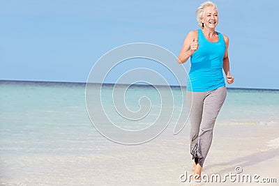 Senior Woman Running On Beautiful Beach