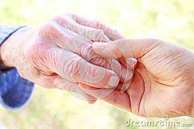 Senior woman s hand and helping hand