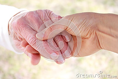 Senior woman s hand and helping hand
