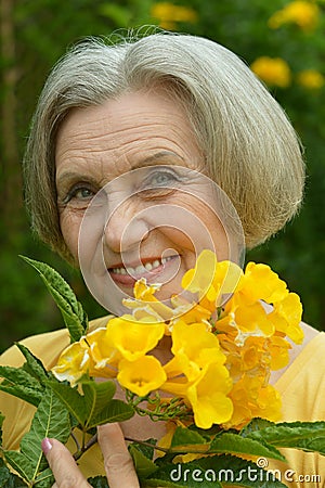 Senior woman with yellow flowers