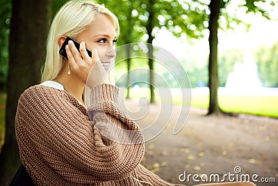 Sensual Blonde In Animated Conversation On Mobile