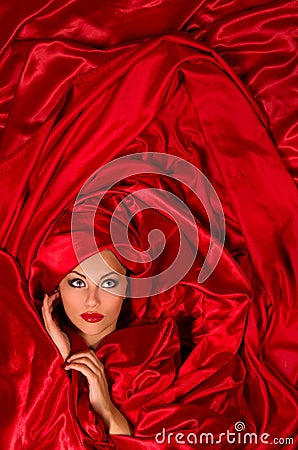 Sensual face in red satin fabric