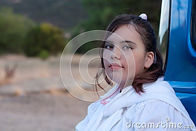 Serious 1950s teen girl in pickup truck