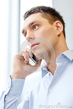 Serious businessman with smartphone