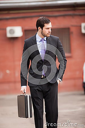 Serious businessman walking on the street