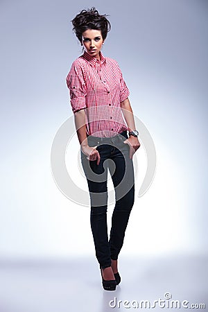 Serious fashion woman in jeans and shirt