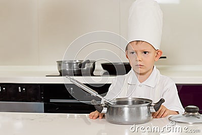 Serious looking little chef in the kitchen