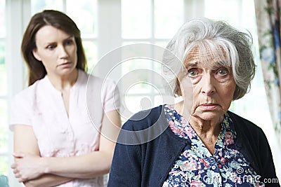 Serious Senior Woman With Worried Adult Daughter At Home