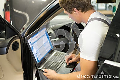 Serviceman in a car workshop