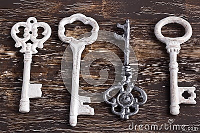 Set of four antique keys, one being different and upside down