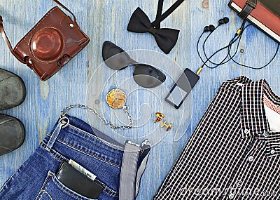 Set of men s clothing and accessories on blue wooden table.