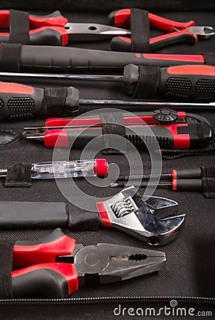 Set of tools and instruments on black fabric background.