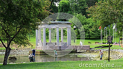 Several men cleaning up the waters in Congress Park,Saratoga Springs,New York,June,2013