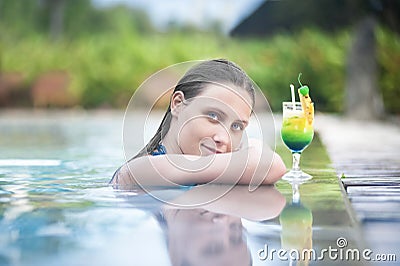 Sexy woman relaxing in the pool with a cocktail