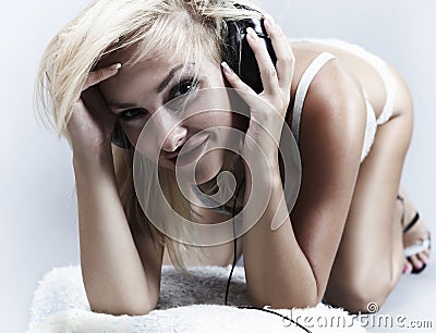 Sexy blond model Listens to music