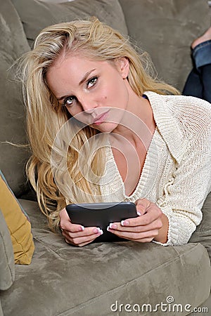 Sexy blonde woman using tablet computer / e-reader