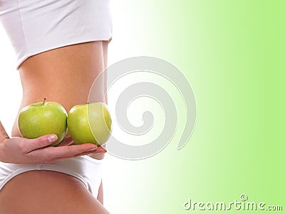 Sexy body of a young woman holding green apples