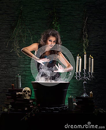 A sexy brunette witch making poison