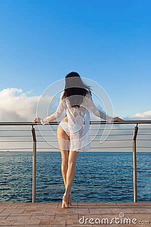 Sexy brunette woman in white bikini