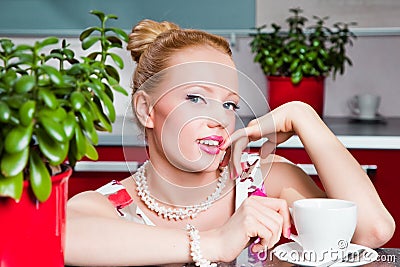 Sexy girl with cup of morning coffee in interior o