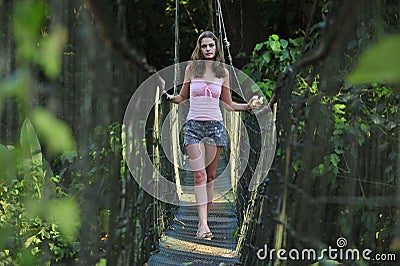 Sexy girl on the rope bridge