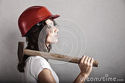 Sexy girl in safety helmet holding hammer tool