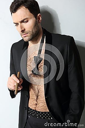 Sexy male model smoking cigar in open