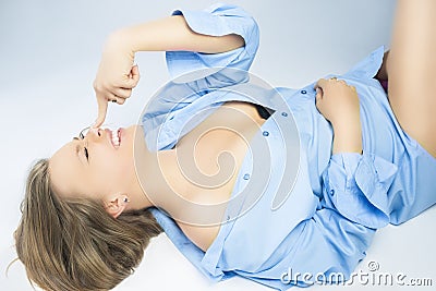 Sexy Playful Caucasian Blond Woman in Nice Blue Shirt Lying on F