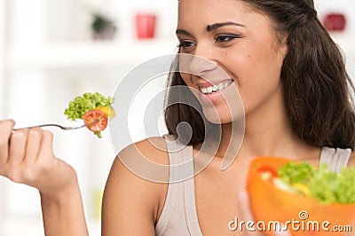 Sexy smiling woman eating salad.