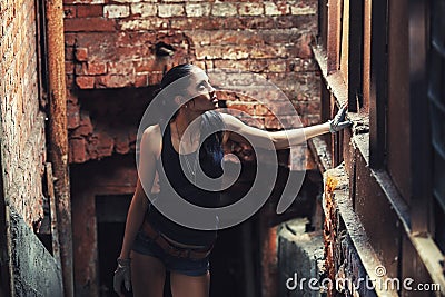 Sexy soldier woman on factory ruins