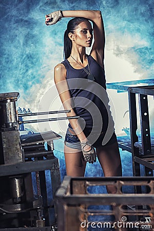 Sexy soldier woman on factory ruins