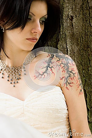 Sexy tattoo woman in bridal dress