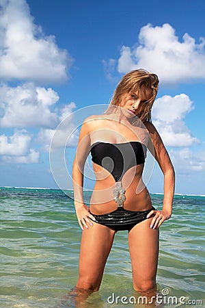 Sexy woman in black bikini on beach