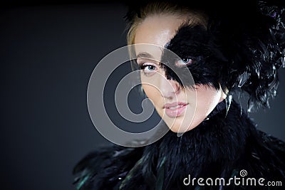Sexy woman with black feather half mask
