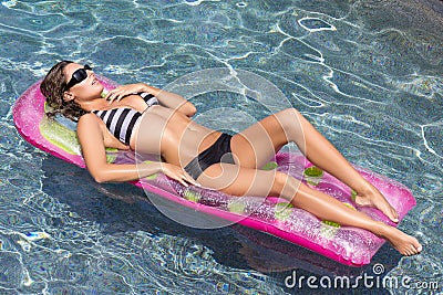 Sexy woman on colorful pool float