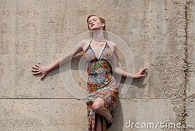 Sexy Woman in Dress Leaning Against Wall